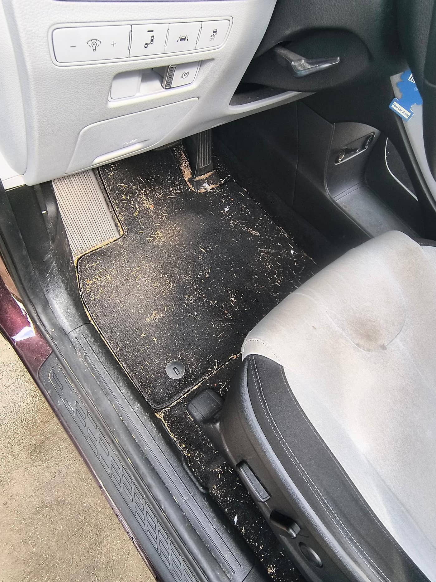 Before: Hyundai SUV driver floor mat covered in debris before Gleam Team interior detail in Charlotte NC