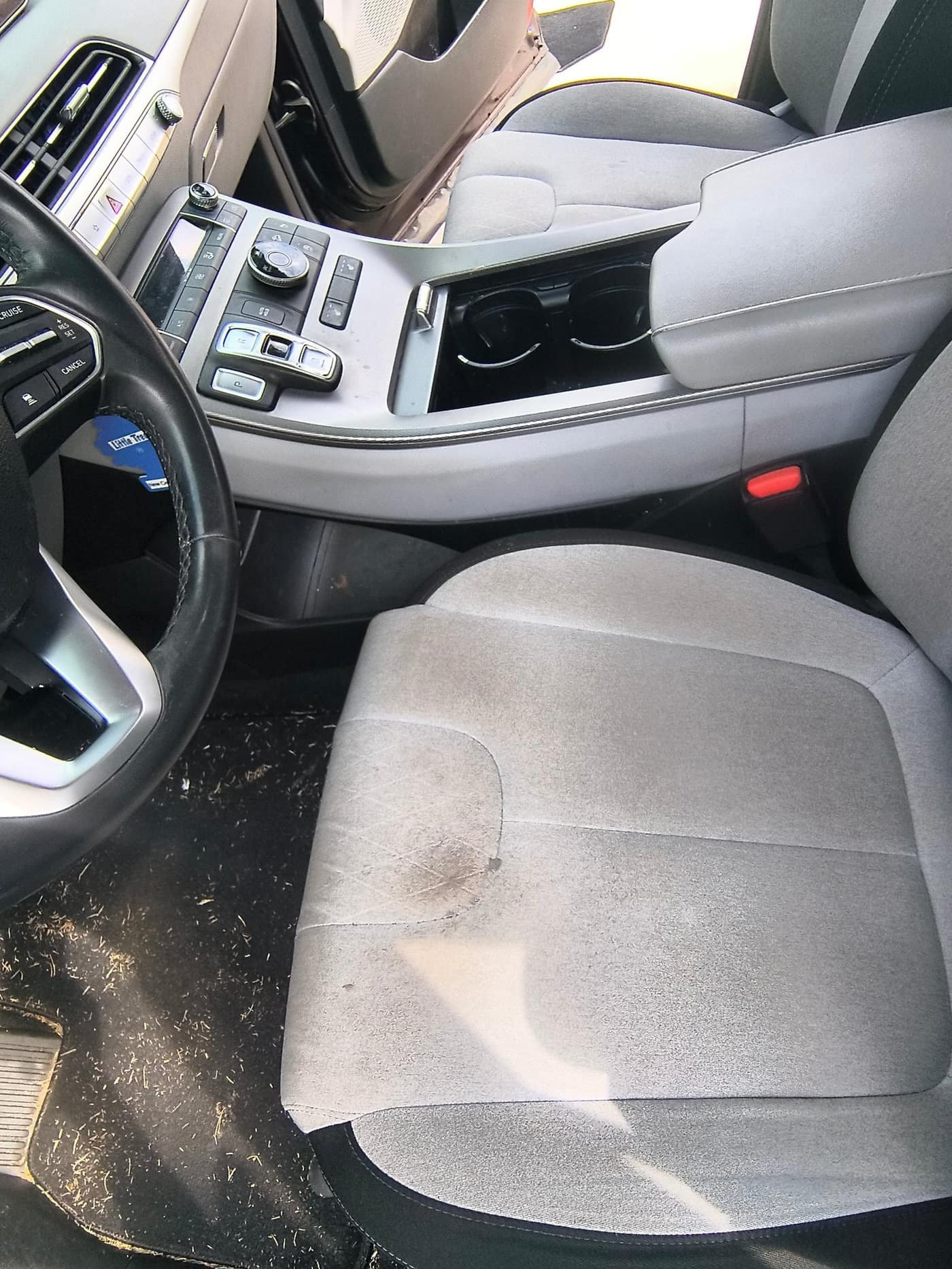 Before: stained Hyundai SUV driver seat and dirty floor before Gleam Team interior detail in Charlotte NC