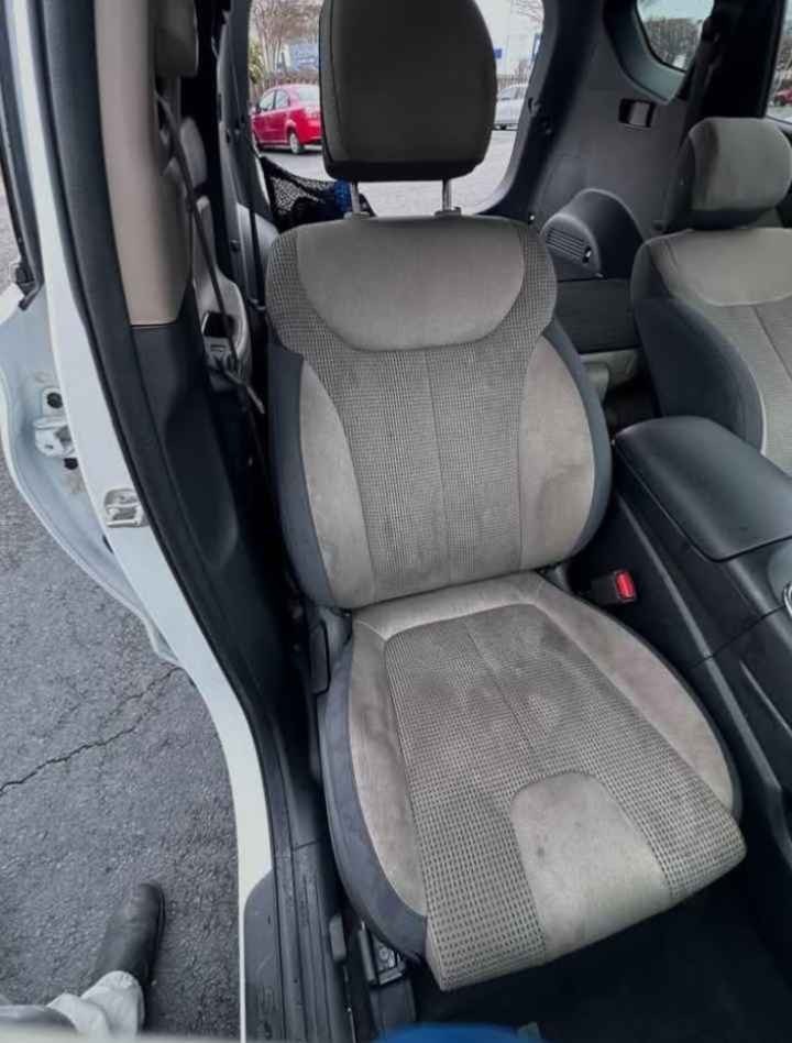 Before: stained two-tone cloth SUV front seat with water rings, body-oil stains and ground-in dirt before Gleam Team hot-water extraction in Charlotte NC